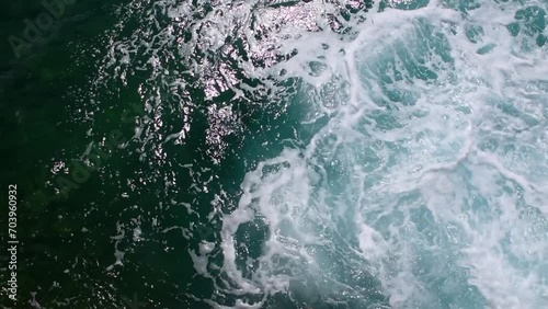 Beautiful turquoise sea waves lapping below with a lot of foam.