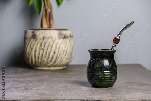 Wallpaper Mural yerba mate cup with a house pland in the background and a pretty bombilla straw plus space for text Torontodigital.ca