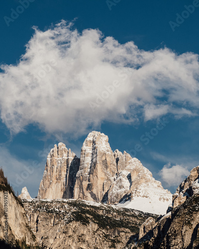 a snowy mountain with a sky background and clouds in the distance