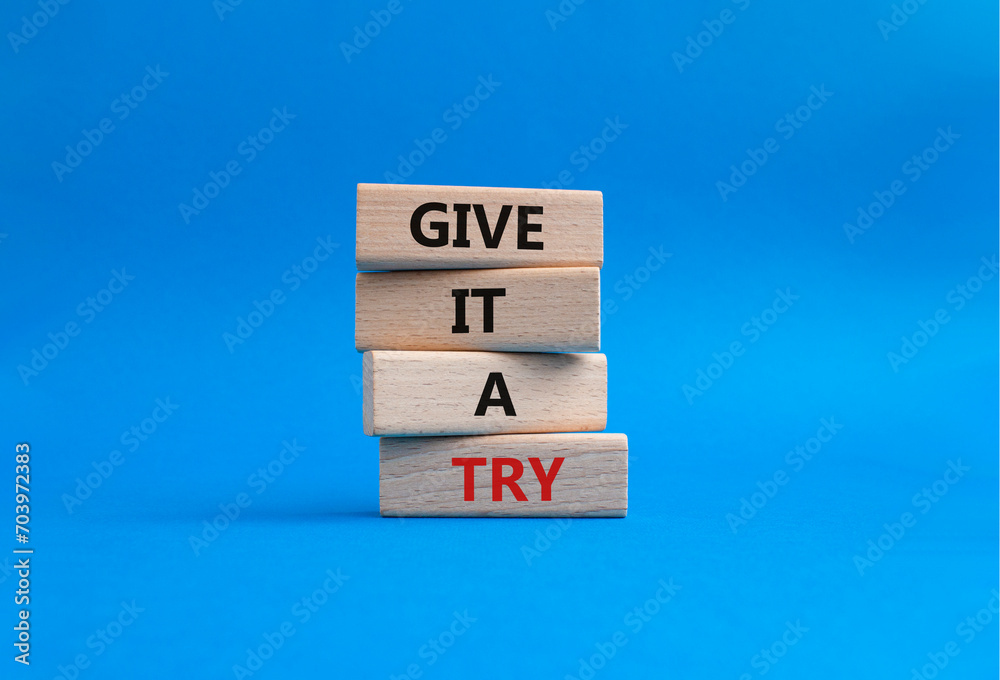 Give it a try symbol. Concept words Give it a try on wooden blocks. Beautiful blue background. Business and Give it a try concept. Copy space. Give it a try symbol. Concept words Give it a try on wooden blocks. Beautiful blue background. Business and Give it a try concept. Copy space.