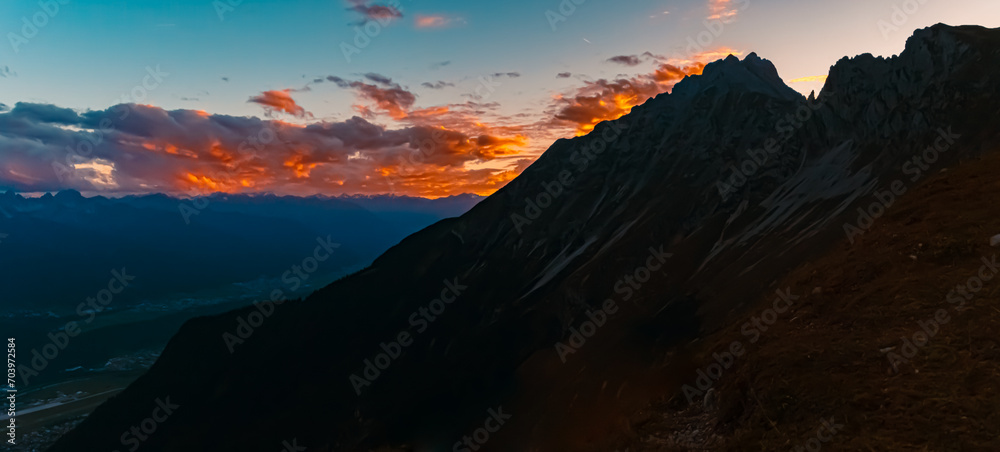 High resolution stitched alpine sunset or sundowner summer panorama at the famous Nordkette mountains near Innsbruck, Tyrol, Austria