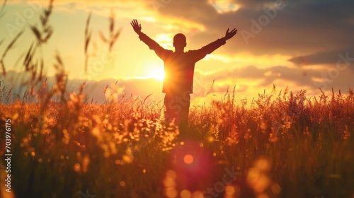 Wellness Recovery Action Plan (WRAP) concept: Silhouette of man raised hands at autumn sunset meadow background