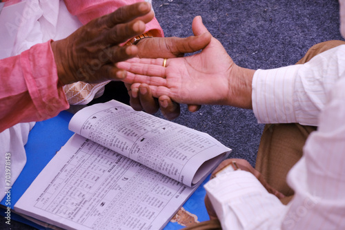 Pune, Maharashtra, India, Palmistry (Palm) Reading, Hast Rekha Reading, A person knowing his future by showing the hand lines on his hand from a Astrologer.
