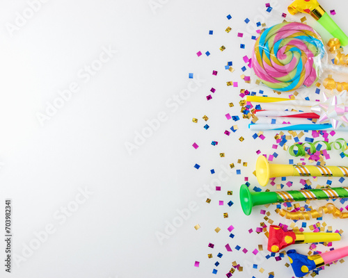 Colorful celebration background with various party confetti  streamers and decoration. Minimal party concept. Flat lay.