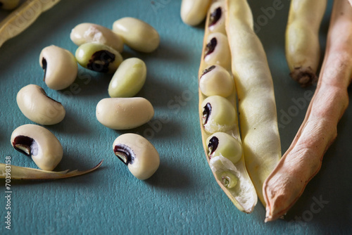 Cow Peas or Black eye Peas on an blue board with their pods