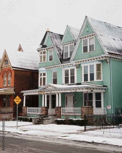 Green house in the snow in Allentown, Buffalo, New York photo