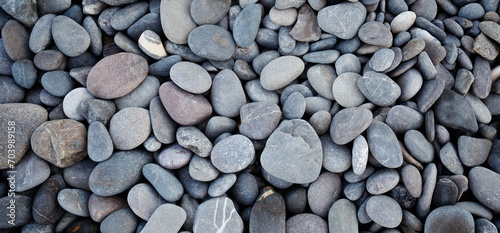 Smooth round pebbles texture background. Pebble sea beach close-up, dark wet pebble and gray dry pebble. High quality photo photo