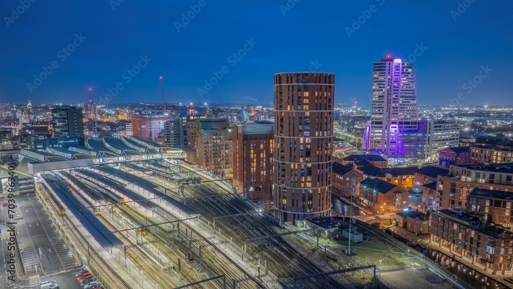Leeds train station, West Yorkshire city centre aerial view. railway transport links. Illuminated at night view overlooking the city