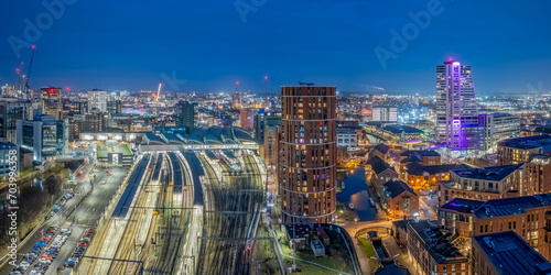 Leeds city centre at Night. Yorkshire city of Leeds after dark with city centre lights of offices, apartments and retail. Aerial view from near the train station photo