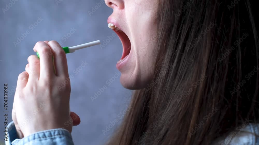 Alleviating the symptoms of a sore throat with the help of a spray. Soothing throat hydration spray. High quality 4k footage Alleviating the symptoms of a sore throat with the help of a spray. Soothing throat hydration spray. High quality 4k footage