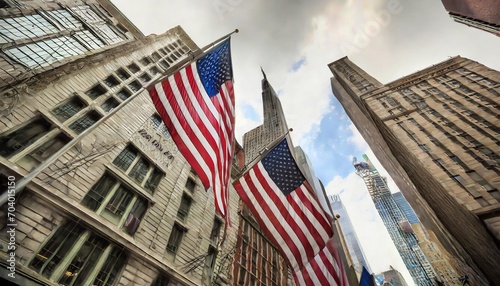 american flags flying in front of the historic buildings of wall street in the financial district of manhattan new york city