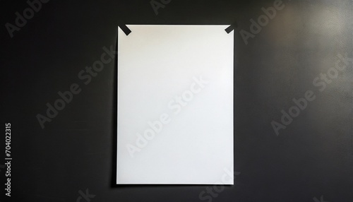 a sheet of white paper glued on a black wall