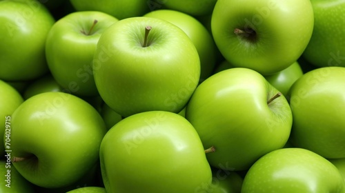  a large pile of green apples with one green apple in the middle of the pile and one green apple in the middle of the pile in the middle of the pile. photo