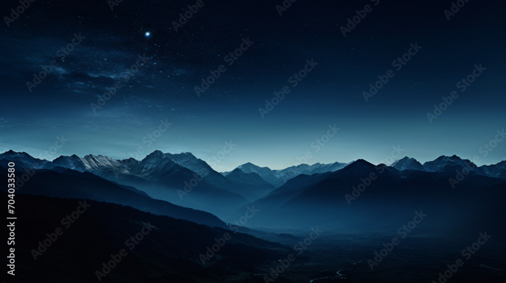A desolate mountain landscape in the moonlight with stark shadows and silhouettes.