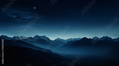 A desolate mountain landscape in the moonlight with stark shadows and silhouettes. © Damian