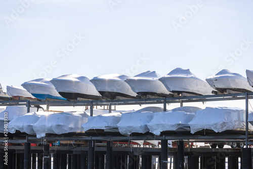 Shrink wrapped power boats on storage racks