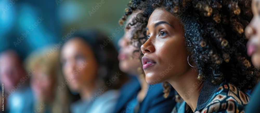 White woman attending HR forum, paying attention to speaker discussing social studies. White woman attending HR forum, paying attention to speaker discussing social studies.