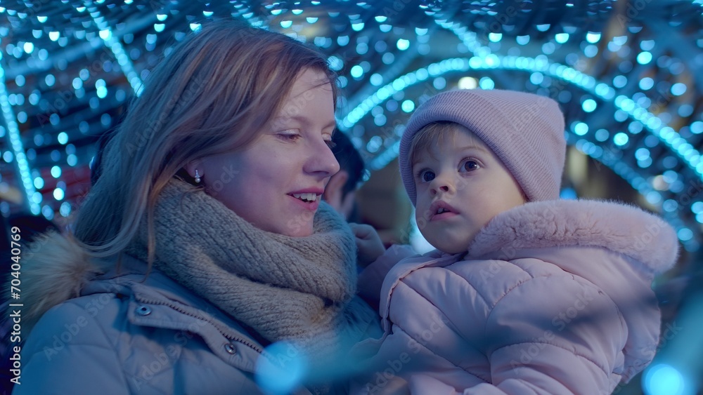 Φωτογραφία Mother with daughter on street for Christmas eve, Christmas lights and christmas mood leisure activity with child