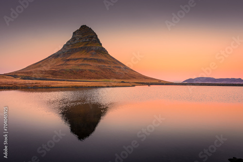 Amazing sunrise view of the Kirkjufell. Symmetric reflection over the lake, Iceland