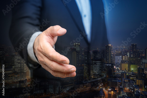 Photography Double exposure of business handshake for successful with city night background, teamwork or partnership concept