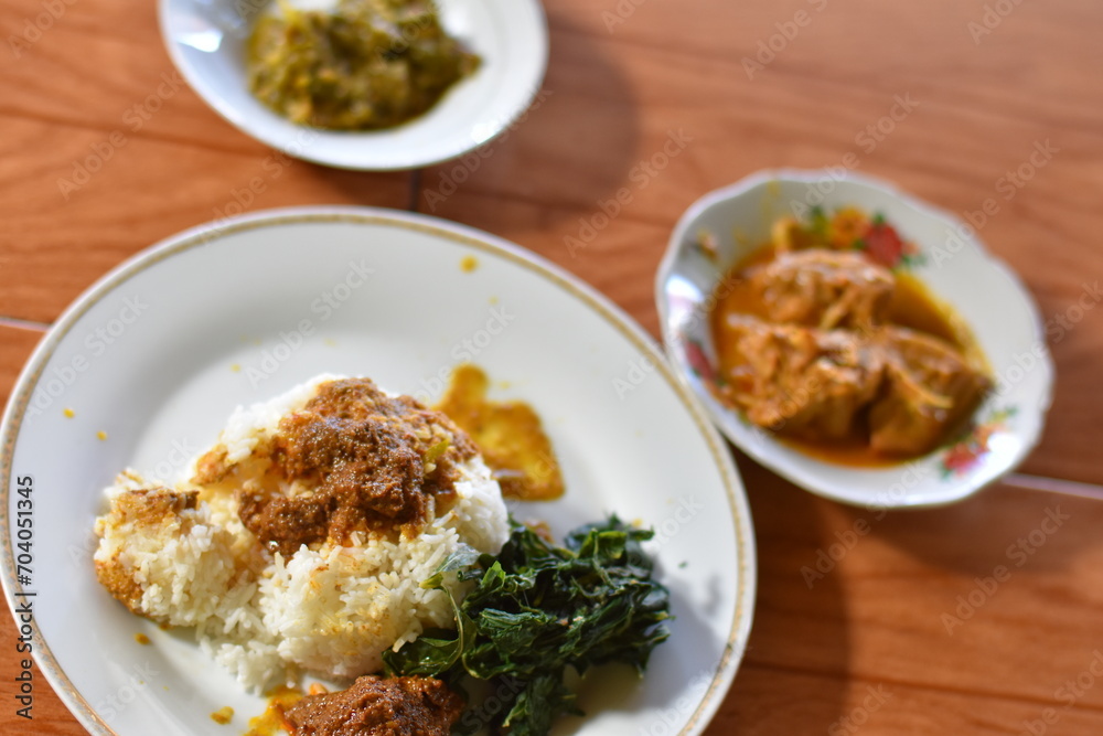 Nasi Padang with rendang is an Indonesian food from West Sumatra in Indonesia. Nasi Padang as favorites food for Indonesian people.
Nasi Padang with rendang is an Indonesian food from West Sumatra in Indonesia. Nasi Padang as favorites food for Indonesian people.
