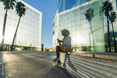 Afro-american lady with smart-phone in urban environment © sururu