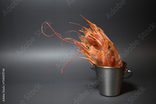 frozen pink queen shrimp in a bucket on a gray background
 photo