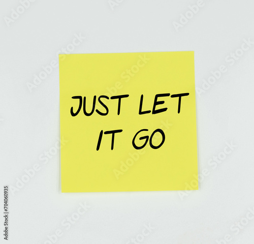 Yellow Post-it with the phrase Just let it go written in black, with a white background 