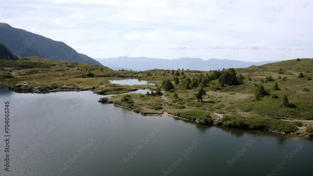 Aerial Forward Scenic Shot Of Rippled Lake On Mountain Against Cloudy Sky - French Alps, France Aerial Forward Scenic Shot Of Rippled Lake On Mountain Against Cloudy Sky - French Alps, France