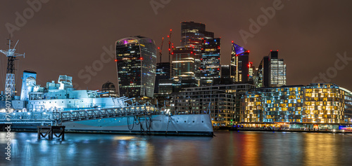 Night view of HMS Belfast, a town-class light cruiser that was built for the Royal Navy, moored as a museum ship on the River Thames in London © Alexey Fedorenko