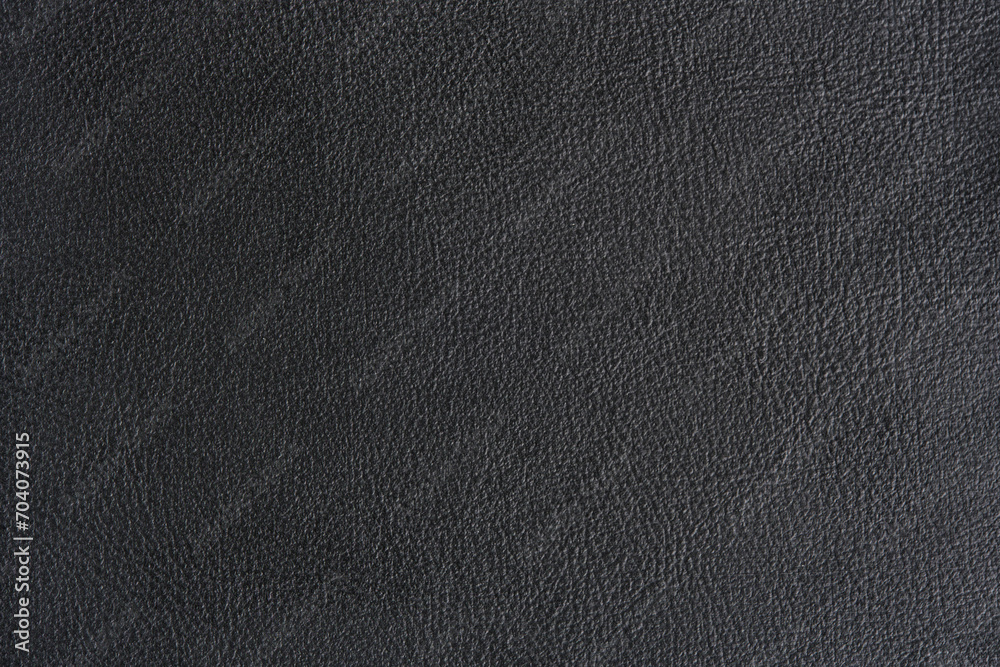 Macro background made of black leather texture.