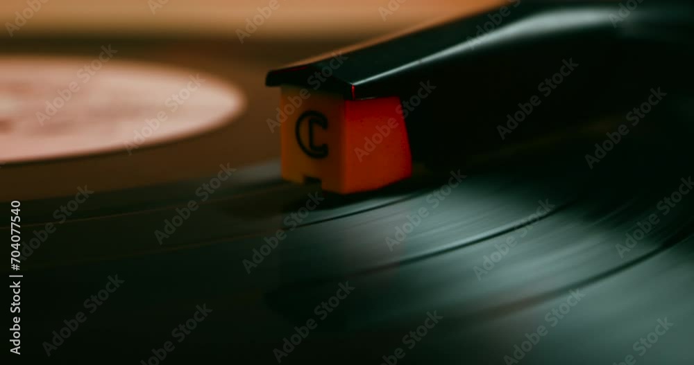 Vinyl record close-up. Vintage old vinil black phonograph spinning. Retro music player on living room home background in evening.