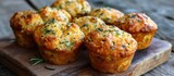 Rustic surface produces perfect cheesy muffins with herbs.