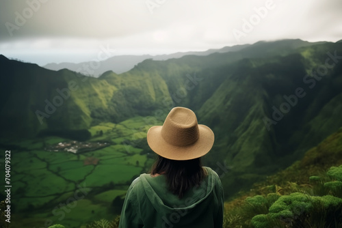 Adventurous Vista: Woman Explorer, Hat Adorned, Captivated by Majestic Mountains and Enchanting Forest