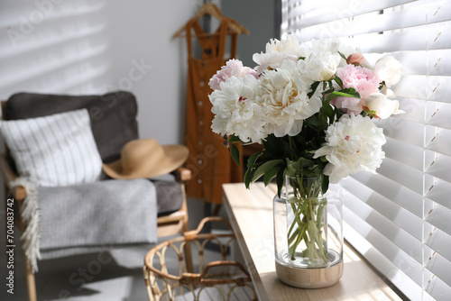 Bouquet of beautiful peony flowers on window sill indoors. Space for text