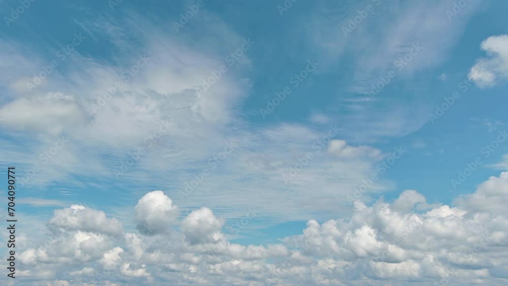 Beautiful, sunny cloudscape can be seen as we fly through heavenly fluffy clouds in blue sky Beautiful, sunny cloudscape can be seen as we fly through heavenly fluffy clouds in blue sky