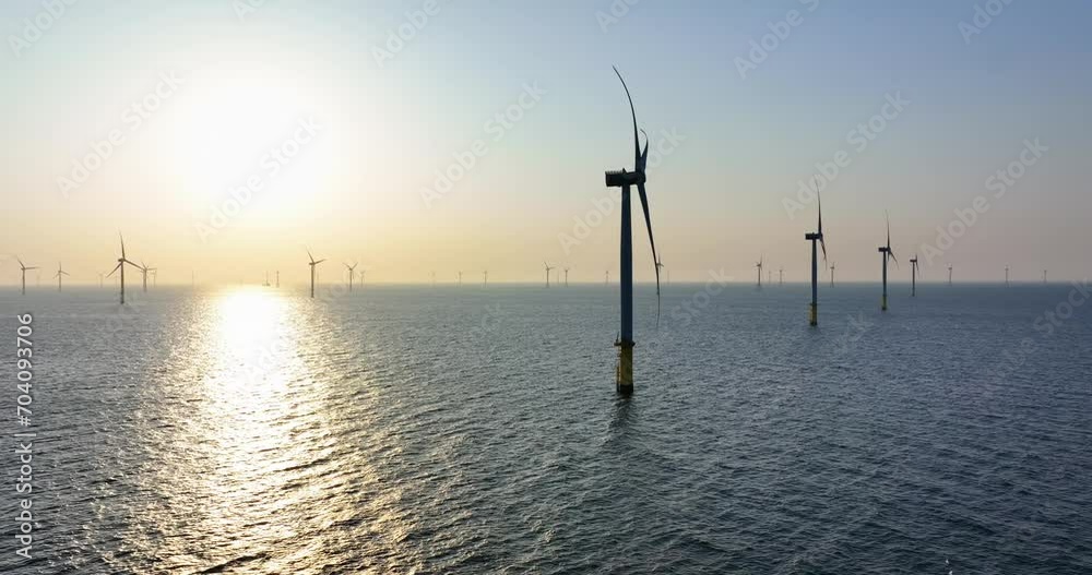 Aerial view of the drone fly over the ocean with wind turbine Aerial view of the drone fly over the ocean with wind turbine