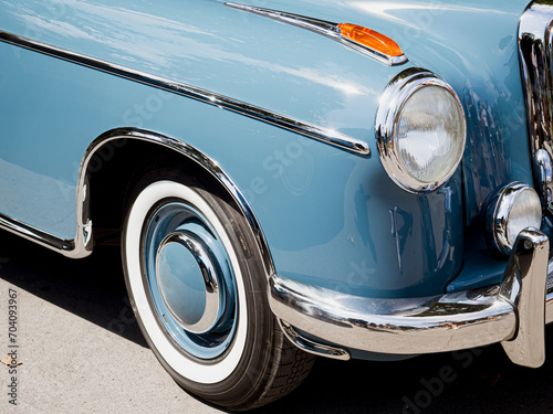 Vintage retro car with close-up on headlights. Front view red muscle car with chromed parts © glebzter