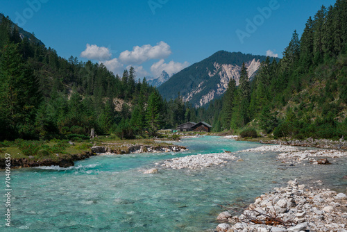 Turquoise river Isar flowing through the Karwendel mountains during sunny blue sky day in summer, Tyrol Austria.