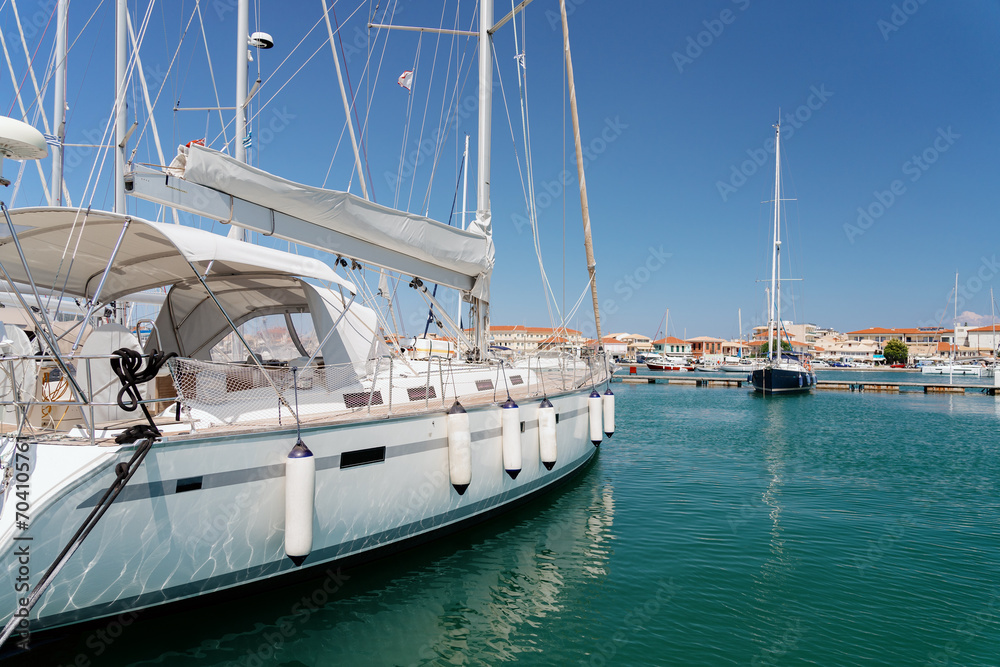 A tranquil marina with luxury sailboats moored along the docks on a clear day, reflecting the essence of nautical leisure