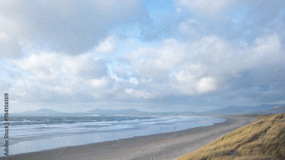 The vast expanse of Harlech beach with the mountains of Snowdonia in the distance.