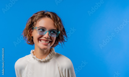 Smiling woman in transparent blue glasses. Positive stylish lady copy space. © kohanova1991