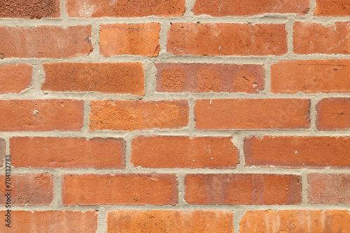 Red brick wall background texture and pattern. This classic and traditional flat masonry build brick wall has a red orange tone.
