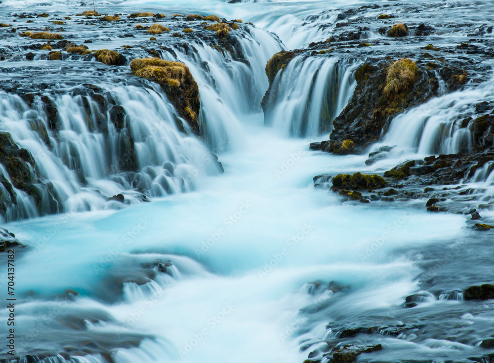 water cascading down a waterfall into shallow gully water cascading down a waterfall into shallow gully