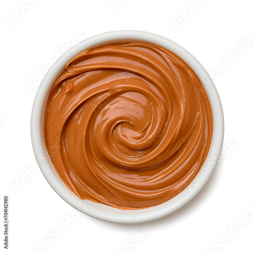 Boiled condensed milk swirl isolated on white background, top view
