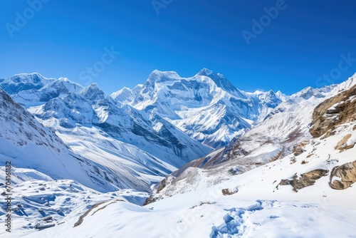 Mountain landscape with snow peaks and clear blue sky