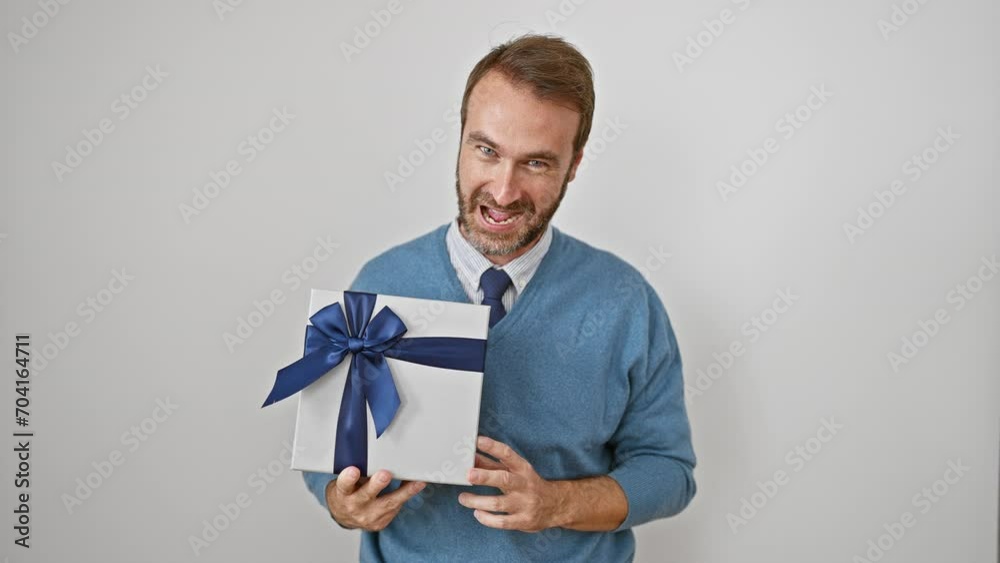 Cheerful middle-aged hispanic man with beard joys in holding a gift, gesturing an ok sign with finger, radiating positive energy on white isolated background Cheerful middle-aged hispanic man with beard joys in holding a gift, gesturing an ok sign with finger, radiating positive energy on white isolated background