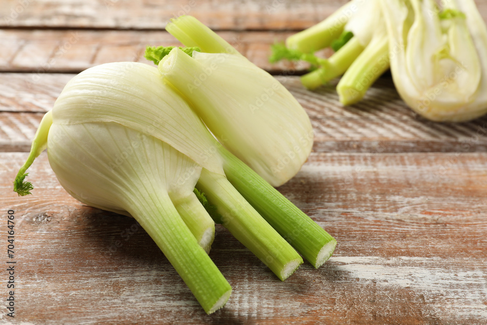 Fresh raw fennel bulbs on wooden table, closeup Fresh raw fennel bulbs on wooden table, closeup