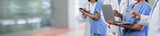 Medical staff team with doctor nurse and specialist working together with laptop and tablet on blur hospital corridor background. Medical and healthcare community in panoramic banner. Neoteric