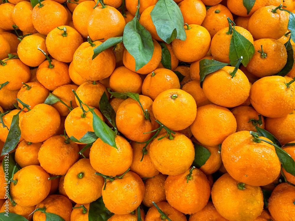 Top view fresh orange fruits with leaves as background, High quality